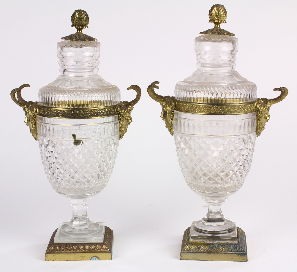 Pair of Neoclassical style cut glass and ormolu lidded urns, the baluster form flanked by mystical