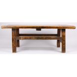 Asian wooden low table, with a single plank top, a plain apron and raised on rectangular supports,