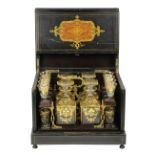 French Napoleon III inlaid tantalus, circa 1870, the ebonized case inlaid with kingwood and mother-