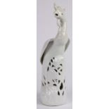 Chinese blanc de chine porcelain phoenix, standing amid pierced peonies, the base marked 'China' and