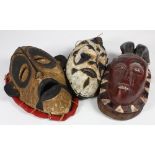 (lot of 30) West African style carved wood decorative face masks including Guerre-Wobe, Bambara,