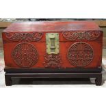 Chinese red lacquered leather trunk, with bat and shou medallion appliques, together with a wood