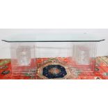 Moderne acrylic low table, having a shaped and beveled plate glass top, above the acrylic base,