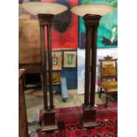 Pair of Moderne torchiere form floor lamps, each with a round glass shade, having four supports, and