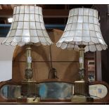 Pair of Hollywood Regency lamps, each with a mother of pearl shell shade, rising on a Corinthian