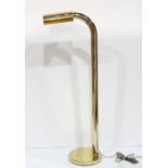 Moderne brass floor lamp, having a single arm suspended from the telescoping standard, and rising on