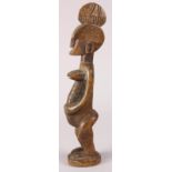 Senufo, Ivory Coast carved wood female figure, accented with a head-dress and body scarification,