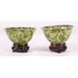 Pair of Chinese green hardstone bowls, 20th century, each with a slightly flared rim and tapering