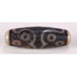 Chinese tianzhu type bead, featuring eleven eyes set against a dark brown ground, 1.75"w