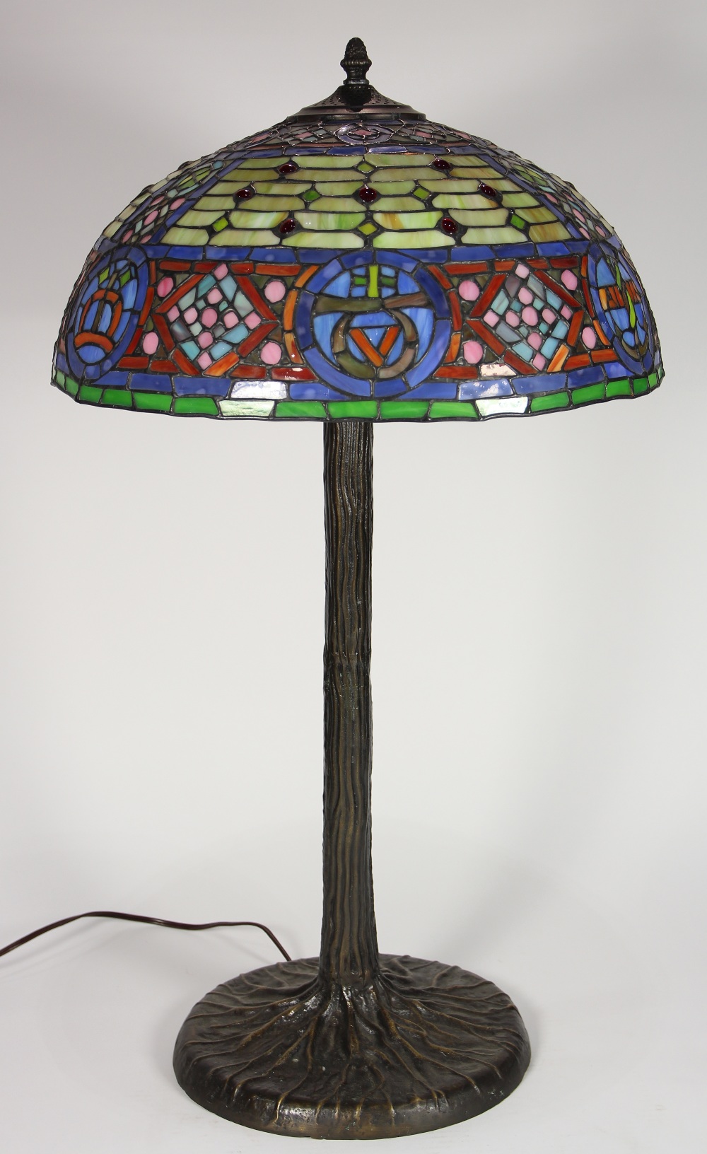 Tiffany style leaded glass table lamp, having a dome shade with multi-colored geometric