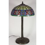 Tiffany style leaded glass table lamp, having a dome shade with multi-colored geometric