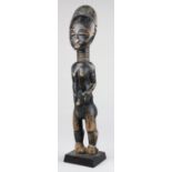 Akan, Ghana, Ivory Coast, standing female figure carved with a rounded head and coiffure, ringed