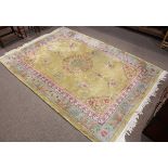 Chinese rug, having a yellow field with floral scrolls, 7' x 9'11"