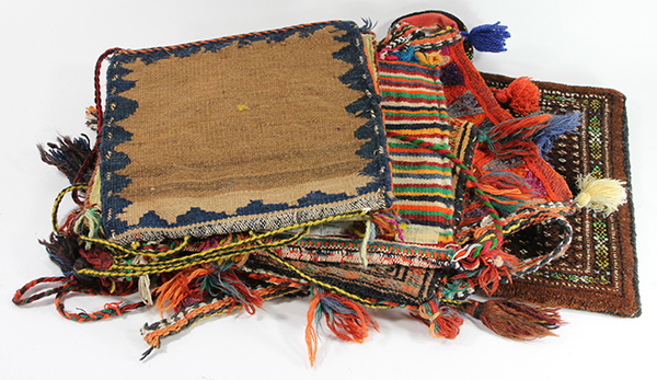 (Lot of 6) Woven wool carpet and Bahtiyari salt bags, with multicolor tassels, straps, and