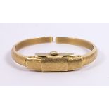 Lady's 14k yellow gold covered wristwatch Dial: rectangle, textured gold, polished baton hour