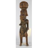 Senufo, Ivory Coast carved seated female figure traditionlly depicted with a basket on her head, and