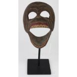 Bali Indonesian monkey-faced mask, 20th Century, executed in carved polychromed decorated wood,