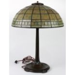 Tiffany Studios, New York, patinated bronze and leaded glass desk lamp, having a geometric decorated