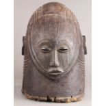 Igala style, Nigeria decorative carved male helmet mask naturalistically depicted with braided