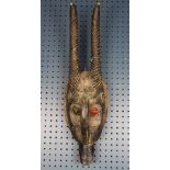 Old and used mask of a horned animal, probably Baule, Cote d'Ivoire, some red paint highlights on