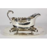 (lot of 2) American Ellmore Silver Company sterling silver sauce-boat and stand, each hand-wrought