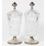 Pair of Hawkes crystal and sterling silver lidded urns, each with lid having a shaped finial,