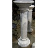 Continental marble pedestal, having a circular top above the columnar standard with grey inclusions,