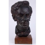 Composition bust of Abraham Lincoln, the whole rising on a wood plinth, signed "Konzal", 14"h