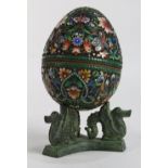 Filigree and enamel egg, ornately decorated with polychrome enamel accents depicting exotic birds