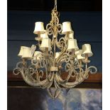 Venetian style patinated metal and crystal chandelier, the tiered form having twelve lights, each