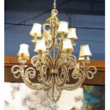 Venetian style patinated metal and crystal chandelier, the tiered form having twelve lights, each