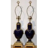 Pair of Continental style urn form table lamps, each having a Classical style form in cobalt blue,