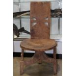 Ethiopian wood chair, probably mid-20th century, carved typically, with a solid form, and sits flat,