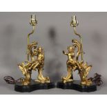 Pair of French ormolu figural lamps, each depicting a putto, one playing a horn, one reading a book,