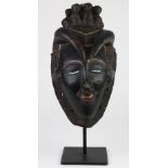 Guro, Cote d'Ivoire mask probably made late 1960s for use uncertain, some red, white and blue