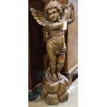 Continental carved wood cherub, 19th century, depicted standing on a naturalistic base, 41"h x 17'