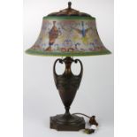 Pairpoint reverse painted table lamp, having a scenic decorated reverse painted "Bombay" form shade,