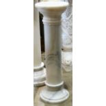 Continental marble pedestal, having a circular top above the columnar standard terminating on a