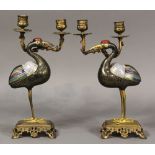 Pair of Chinese cloisonne crane form candle holders, each with a red-headed black crane, clasping