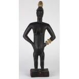 Guro, Cote d'Ivoire style, decorative standing female figure wearing bracelets on her left wrist,