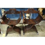 Pair of Renaissance style savonarola chairs, circa 1880, each having a carved back, and rising on an