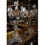 Pair of French Louis XV style bronze 9-light figural candelabra, each standard as a putto rasing a