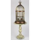 (Lot of 2) Copper and brass birdcage, with two copper food bowls and a reeded wood swing, having a