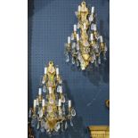 Pair of gilt bronze and rock crystal sconces, each having nine lights, above crystal drops, 24"h.