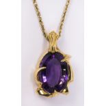 Amethyst and yellow gold pendant-necklace featuring (1) oval cut amethyst weighing approximately