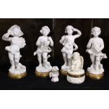 (Lot of 6) Bisque porcelain figural group, the white porcelain cherubs rising on gilded circular