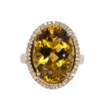 Citrine, diamond and 14k yellow gold ring featuring (1) oval cut citrine weighing approximately 12.