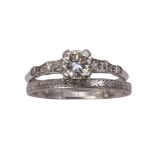 Diamond and platinum engagement ring and wedding band featuring (1) round brilliant cut diamond