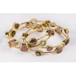 (Lot of 4) Tourmaline and silver gilt stacking bangle bracelets set with various abstract rose cut