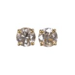 Pair of diamond and 18k yellow gold ear studs featuring (2) round brilliant cut diamonds weighing in